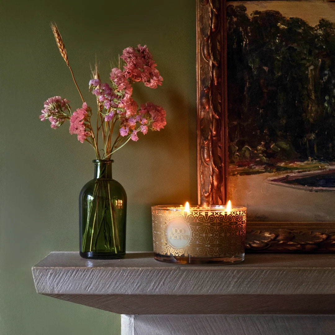 Golden Winter candle on a mantelpiece